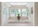 Bright sunroom with multiple windows, plantation shutters, and a decorative rug at 7601 Newport Bay Dr # 115, Indianapolis, IN 46240