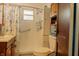 Well-lit bathroom featuring a walk-in shower and classic cabinetry at 7727 Huff St, Indianapolis, IN 46259