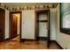 Bedroom showcasing original wood floors, trim, and a closet at 7727 Huff St, Indianapolis, IN 46259