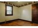 Bedroom featuring hardwood floors, wallpaper accents, and a bright window at 7727 Huff St, Indianapolis, IN 46259