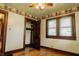 Bright bedroom showcasing original wood floors, trim, and a closet at 7727 Huff St, Indianapolis, IN 46259