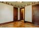 Bedroom featuring hardwood floors, wallpaper accents, and classic wood trim at 7727 Huff St, Indianapolis, IN 46259