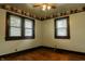 Cozy bedroom with hardwood floors, wallpaper accents, and a bright window at 7727 Huff St, Indianapolis, IN 46259