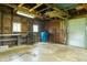 A garage with a work bench and overhead lighting is equipped with a rolling garage door at 7727 Huff St, Indianapolis, IN 46259