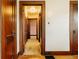 Hallway featuring hardwood floors, classic wood trim and multiple entry doors at 7727 Huff St, Indianapolis, IN 46259