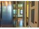 Hallway showing stainless steel refrigerator, tiled floor, and door leading to another room at 7727 Huff St, Indianapolis, IN 46259