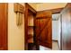 Hallway featuring hardwood floors, built-in shelving and a classic door at 7727 Huff St, Indianapolis, IN 46259