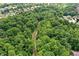 Expansive aerial view of a wooded area, showcasing a walking path and surrounding neighborhood at 773 Bracknell Dr, Avon, IN 46123