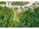 Aerial view of a home featuring a private backyard, enveloped by lush trees and a paved path at 773 Bracknell Dr, Avon, IN 46123