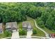 Aerial view of two homes with manicured lawns, surrounded by mature trees and a private driveway at 773 Bracknell Dr, Avon, IN 46123