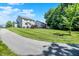 Large grassy backyard and house exterior, complemented by a paved pathway and mature trees at 773 Bracknell Dr, Avon, IN 46123