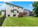 Backyard with green grass, a black fence, and a brown deck with a walkout at 773 Bracknell Dr, Avon, IN 46123