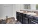 Bathroom with double sinks, a granite counter, and dark cabinetry at 773 Bracknell Dr, Avon, IN 46123