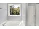 Bathroom with a large tub, separate shower and big window overlooking trees at 773 Bracknell Dr, Avon, IN 46123