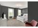 Cozy bedroom with gray walls, chandelier, and two windows with curtains at 773 Bracknell Dr, Avon, IN 46123