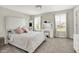 Bright bedroom with two windows, vanity, neutral walls and carpet, and large bed with white bedding at 773 Bracknell Dr, Avon, IN 46123