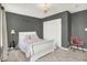 Bedroom with gray walls, a white sleigh bed, chandelier and pink chair at 773 Bracknell Dr, Avon, IN 46123