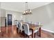 Bright dining room featuring a modern light fixture, a dark wood table, and hardwood floors at 773 Bracknell Dr, Avon, IN 46123
