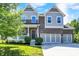 Two-story home with brick and siding, front porch, and three-car garage in a residential neighborhood at 773 Bracknell Dr, Avon, IN 46123