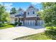 A two-story home with a three-car garage, and a well-manicured lawn, and a front porch at 773 Bracknell Dr, Avon, IN 46123