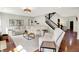 Spacious living room featuring hardwood floors, a comfortable couch and an adjacent staircase at 773 Bracknell Dr, Avon, IN 46123