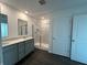 Contemporary bathroom features a double vanity, granite countertops, and a tiled glass shower enclosure at 7909 Magnolia St, New Palestine, IN 46163
