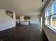 Open concept living space featuring hardwood floors, recessed lighting, and large windows with a view of the lake at 7909 Magnolia St, New Palestine, IN 46163