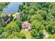Aerial view of the home with landscaped lawns surrounded by a dense canopy of trees at 8004 Lafayette Rd, Indianapolis, IN 46278