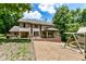 Expansive backyard with a wooden deck, covered patio, playset, and a hot tub, perfect for outdoor fun at 8004 Lafayette Rd, Indianapolis, IN 46278