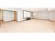 Finished basement with carpet and a blank projector screen for a home theater experience at 8004 Lafayette Rd, Indianapolis, IN 46278