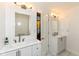 Bathroom with double sink vanity and mirror with modern light fixtures at 8004 Lafayette Rd, Indianapolis, IN 46278