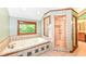 Primary bath with garden tub, stand up shower, and a view at 8004 Lafayette Rd, Indianapolis, IN 46278