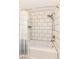Bathroom tub and shower featuring subway tile and updated fixtures at 8004 Lafayette Rd, Indianapolis, IN 46278