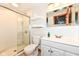 Bathroom featuring a glass-enclosed shower, white vanity, and a large decorative mirror at 8004 Lafayette Rd, Indianapolis, IN 46278