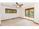 Carpeted bedroom with windows featuring wood trim and a ceiling fan at 8004 Lafayette Rd, Indianapolis, IN 46278