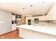 Beautiful white kitchen with quartz counters, stainless steel appliances, and hardwood flooring at 8004 Lafayette Rd, Indianapolis, IN 46278