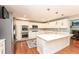 Stylish kitchen boasts white cabinets, stainless steel appliances, hardwood floors, and modern fixtures at 8004 Lafayette Rd, Indianapolis, IN 46278