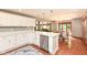 Bright modern kitchen featuring white cabinets, stainless steel appliances, and hardwood floors at 8004 Lafayette Rd, Indianapolis, IN 46278