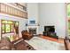 Inviting living room featuring a stone fireplace, hardwood floors, and comfortable leather seating at 8004 Lafayette Rd, Indianapolis, IN 46278