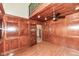 Office with wood paneling, hardwood floors, and built-in shelves at 8004 Lafayette Rd, Indianapolis, IN 46278