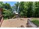 Backyard play area featuring a wooden playset, swing set, slide, and mulch groundcover at 8004 Lafayette Rd, Indianapolis, IN 46278