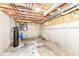 Unfinished basement with exposed pipes, wires, and insulation; offering potential for customization at 8004 Lafayette Rd, Indianapolis, IN 46278