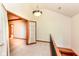 Upstairs landing with view of staircase, chandelier, and decorative beams at 8004 Lafayette Rd, Indianapolis, IN 46278