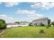 Spacious backyard featuring a white fence, garden beds, and well-maintained lawn at 8126 Kilborn Way, Avon, IN 46123