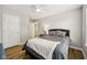 Bedroom features a bed, wood-look floors, ceiling fan, and ensuite bath at 8126 Kilborn Way, Avon, IN 46123