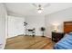Bedroom with ceiling fan, wood-look floors, and a double door closet at 8126 Kilborn Way, Avon, IN 46123