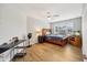 Bedroom with wood-look floors, ceiling fan, and a large window at 8126 Kilborn Way, Avon, IN 46123
