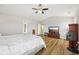 Bedroom featuring neutral walls, wood-look floors, a ceiling fan, and a mounted television at 8126 Kilborn Way, Avon, IN 46123