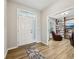 Inviting foyer featuring hardwood floors and a glass-paneled front door, leading to a cozy living space at 8126 Kilborn Way, Avon, IN 46123
