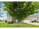 Charming home with lush green lawn, mature shade tree, and inviting front porch, showcasing curb appeal at 8126 Kilborn Way, Avon, IN 46123